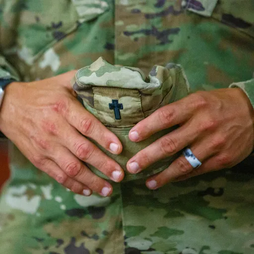 chaplain holding hat