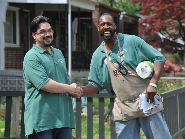 two InFaith volunteers shaking hands