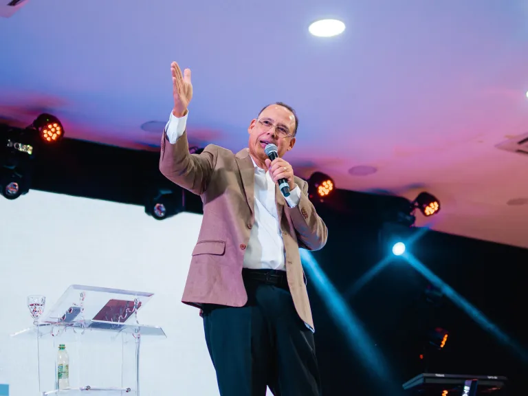 pastor preaching on stage to congregation