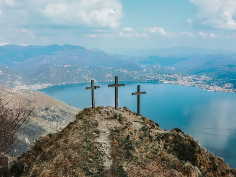 three wooden crosses on a hill
