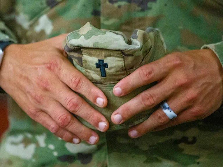 chaplain holding hat