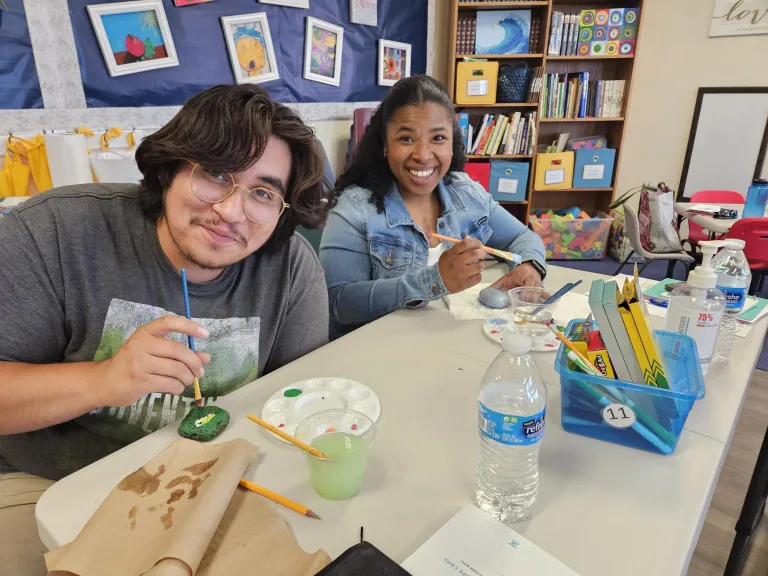 2 people painting