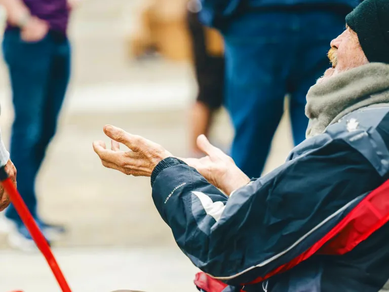 Homeless man with hands up