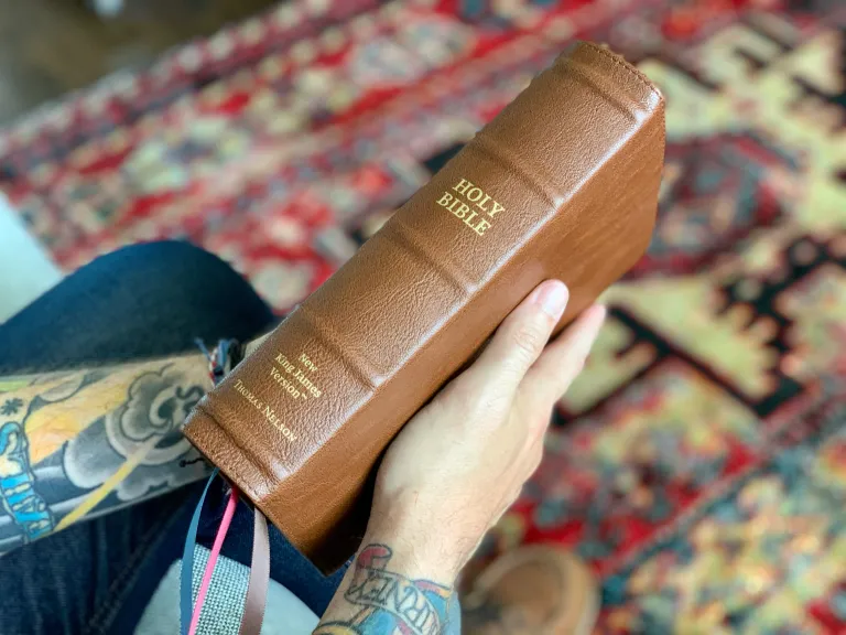 holding the bible