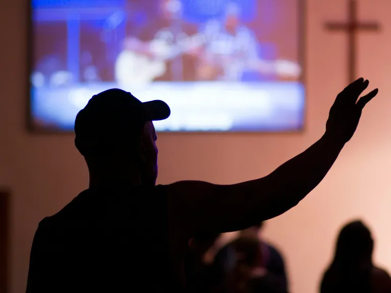 man with hat worshipping