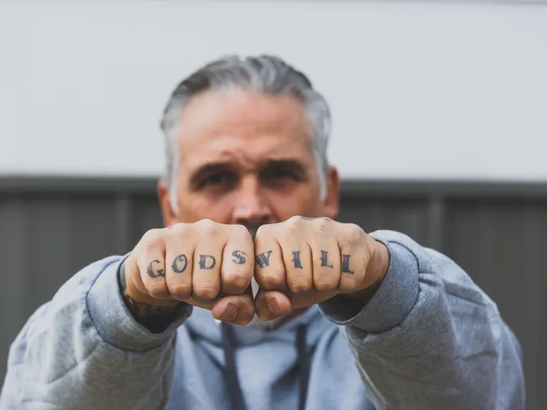 man with tattoed hands