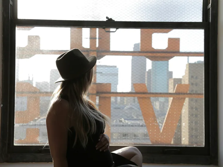 pregnant laady looking out window