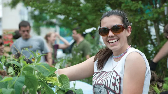young adult ministry teenager working outdoors in a community garden
