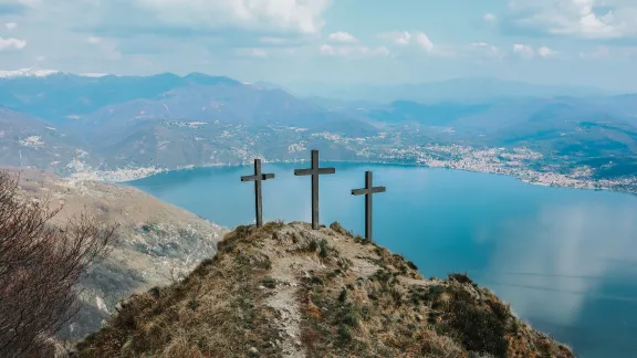 three wooden crosses on a hill