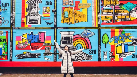 Mira Kim in front of banner