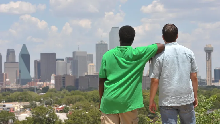 two men overlooking large city from a distance