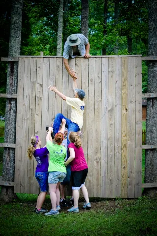 team work on climbing wall