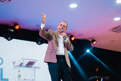 pastor preaching on stage to congregation