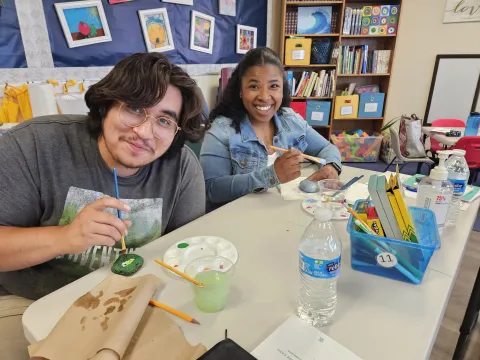 2 people painting