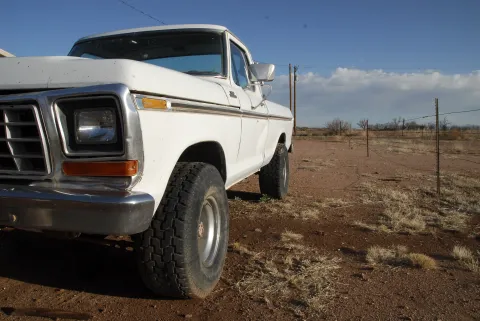 truck in a desert ready to be worked on by a missionary