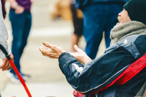 Homeless man with hands up